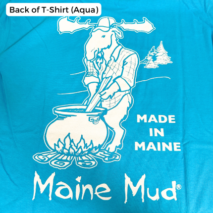 An aqua blue t-shirt design with a moose in a flannel stirring a large pot of caramel over a campfire. The text reads "Made in Maine" and "Maine Mud"