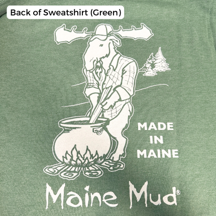 An pale green crewneck design with a moose in a flannel stirring a large pot of caramel over a campfire. The text reads "Made in Maine" and "Maine Mud"