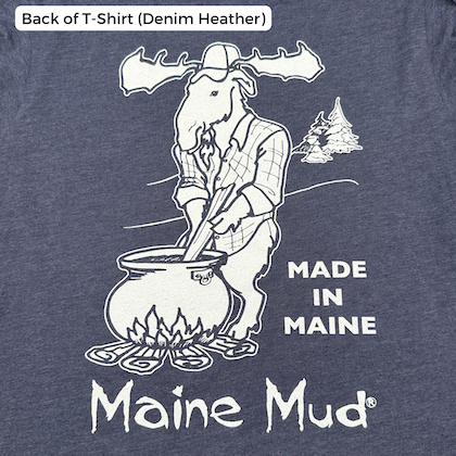 A t-shirt in denim heather with a moose in a flannel stirring a large pot of caramel over a campfire. The text reads "Made in Maine" and "Maine Mud"